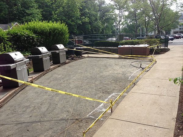 A row of grills are lined up on a sidewalk behind yellow tape