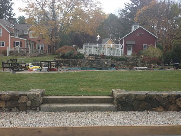 A large lawn with a red house in the background