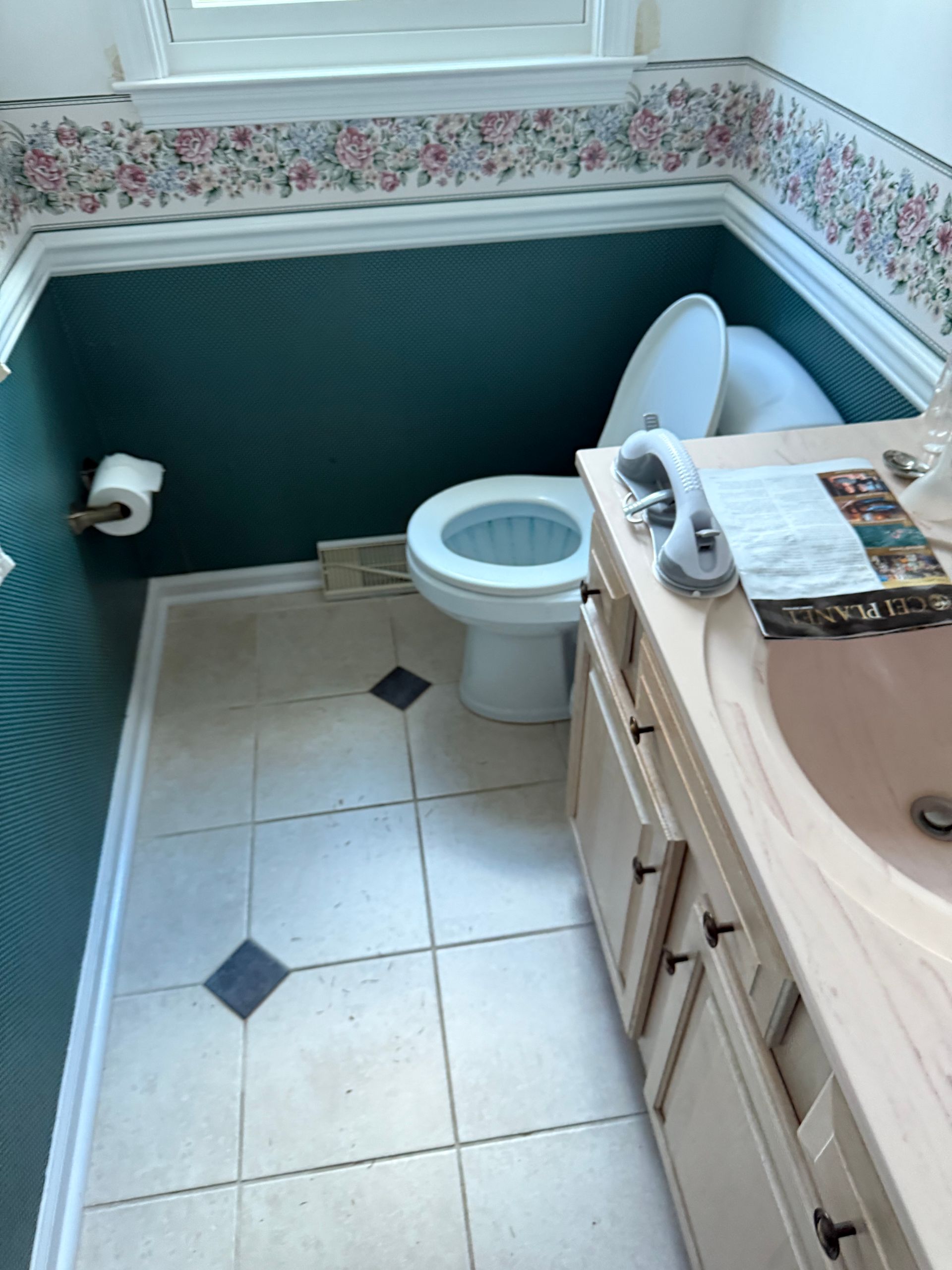 A bathroom with a toilet a sink and a mirror