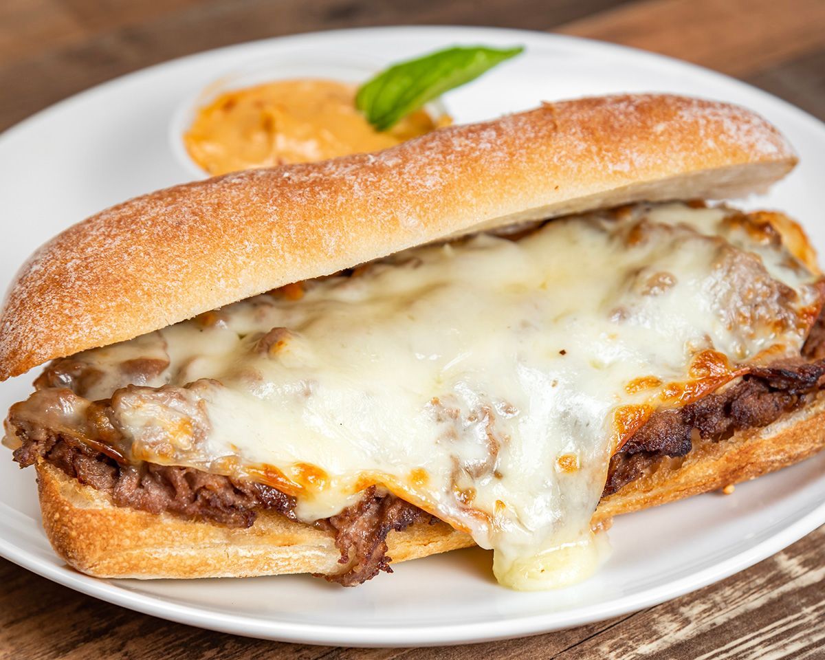 A close up of a sandwich on a plate on a table.