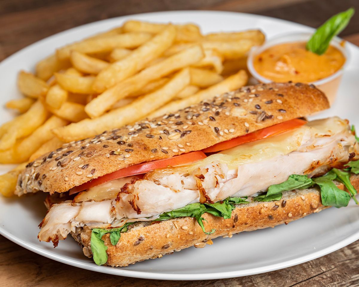 A sandwich and french fries on a white plate