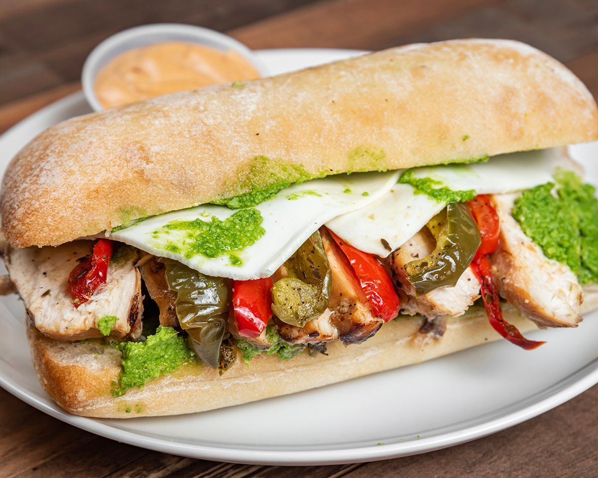 A close up of a sandwich on a plate on a table.