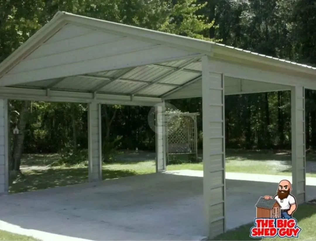 White carport with metal roof, set on a concrete pad with surrounding grass and trees.