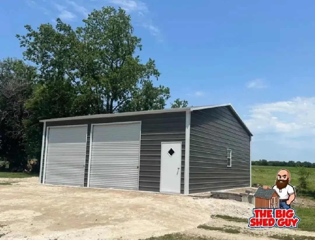 Gray metal garage with two roll-up doors, a white door, and the logo