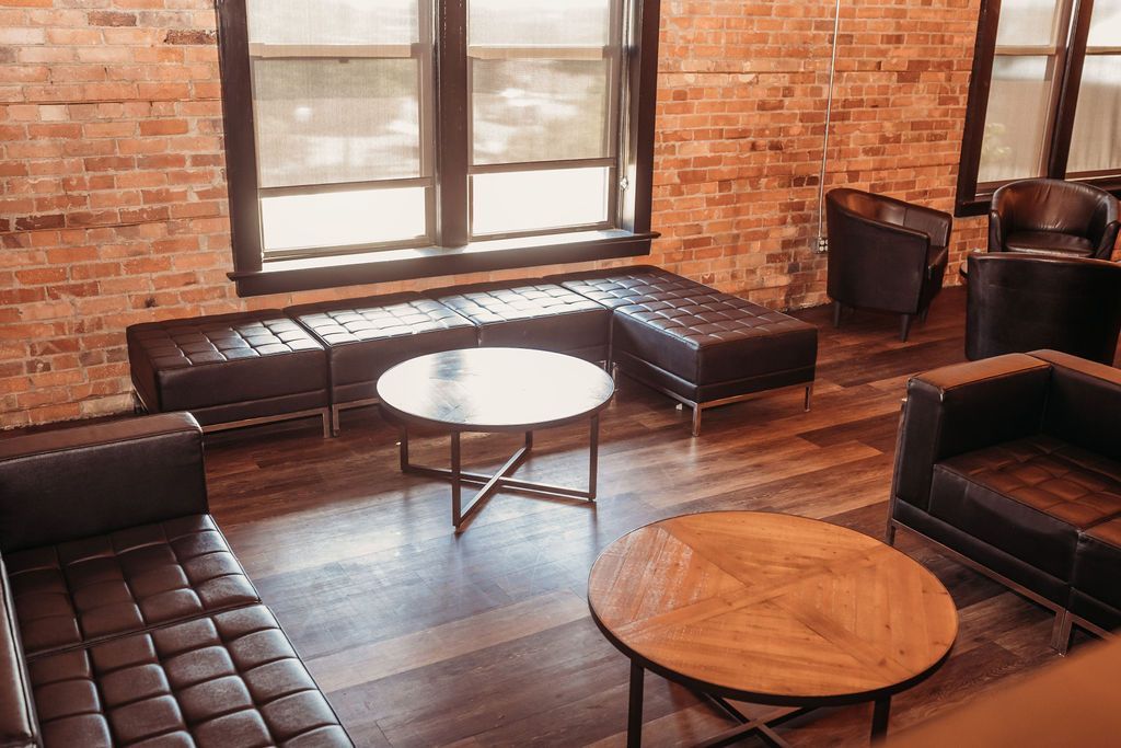 A living room with a couch, chairs, and a coffee table