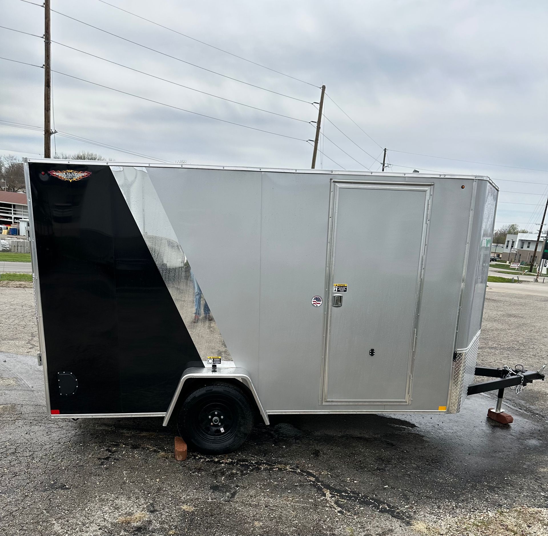 A white trailer is parked on the side of the road.
