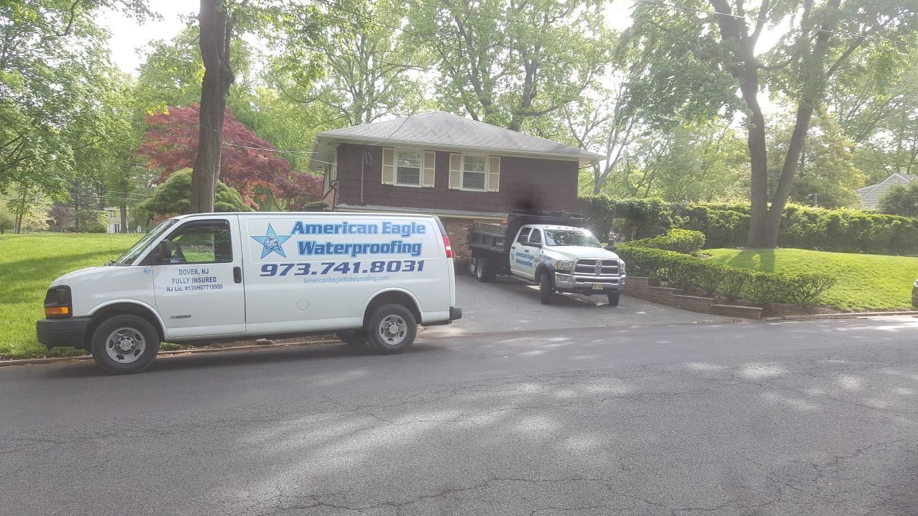 A white van is parked in front of a house.