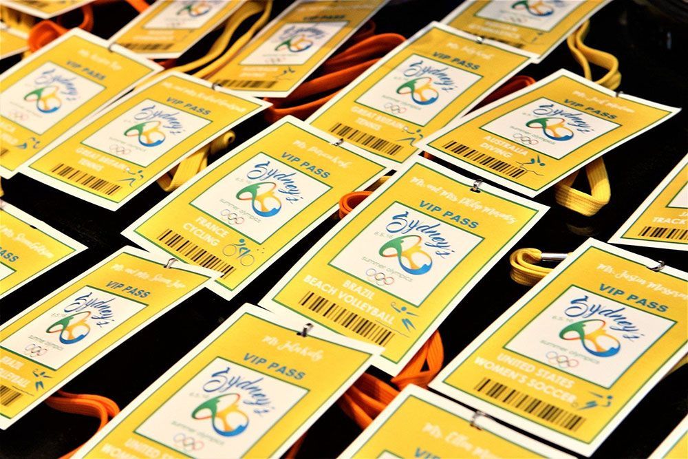 VIP passes with lanyards for the Sydney 2000 Olympics, gold and teal design.