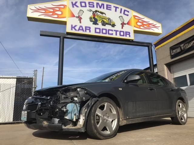 Damaged black car in front of