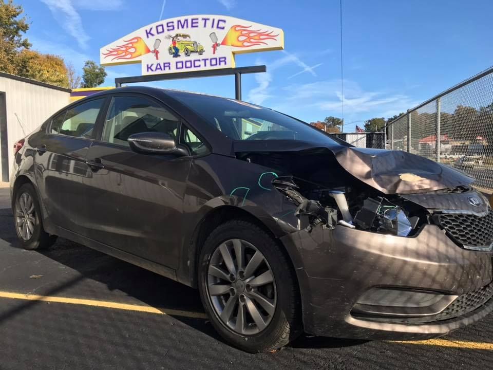 Damaged brown Kia Forte car at