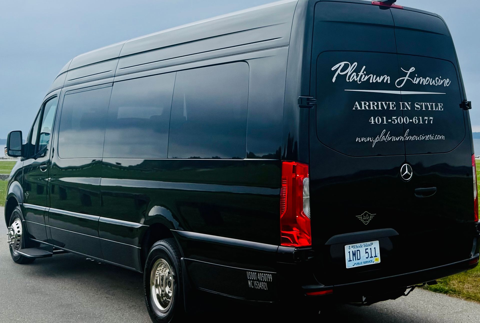 Black Platinum Limousines van parked on the pavement. Text on the side.
