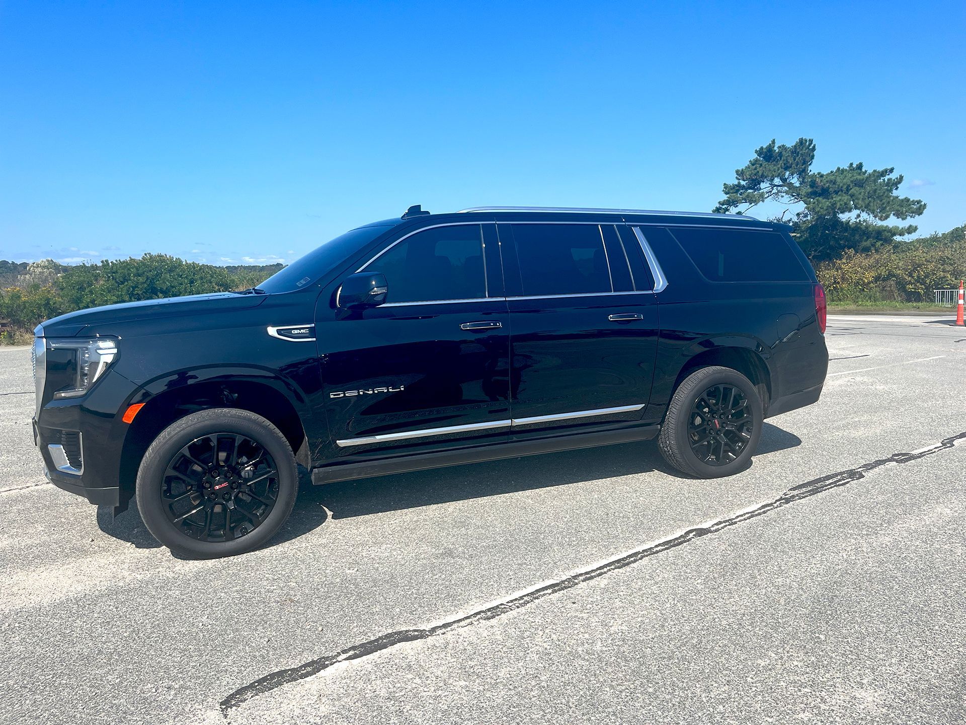 A black suv is parked on the side of the road.
