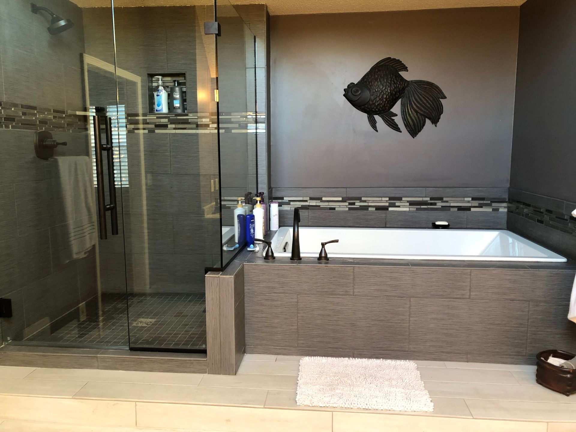 A bathroom with a bathtub and a walk in shower