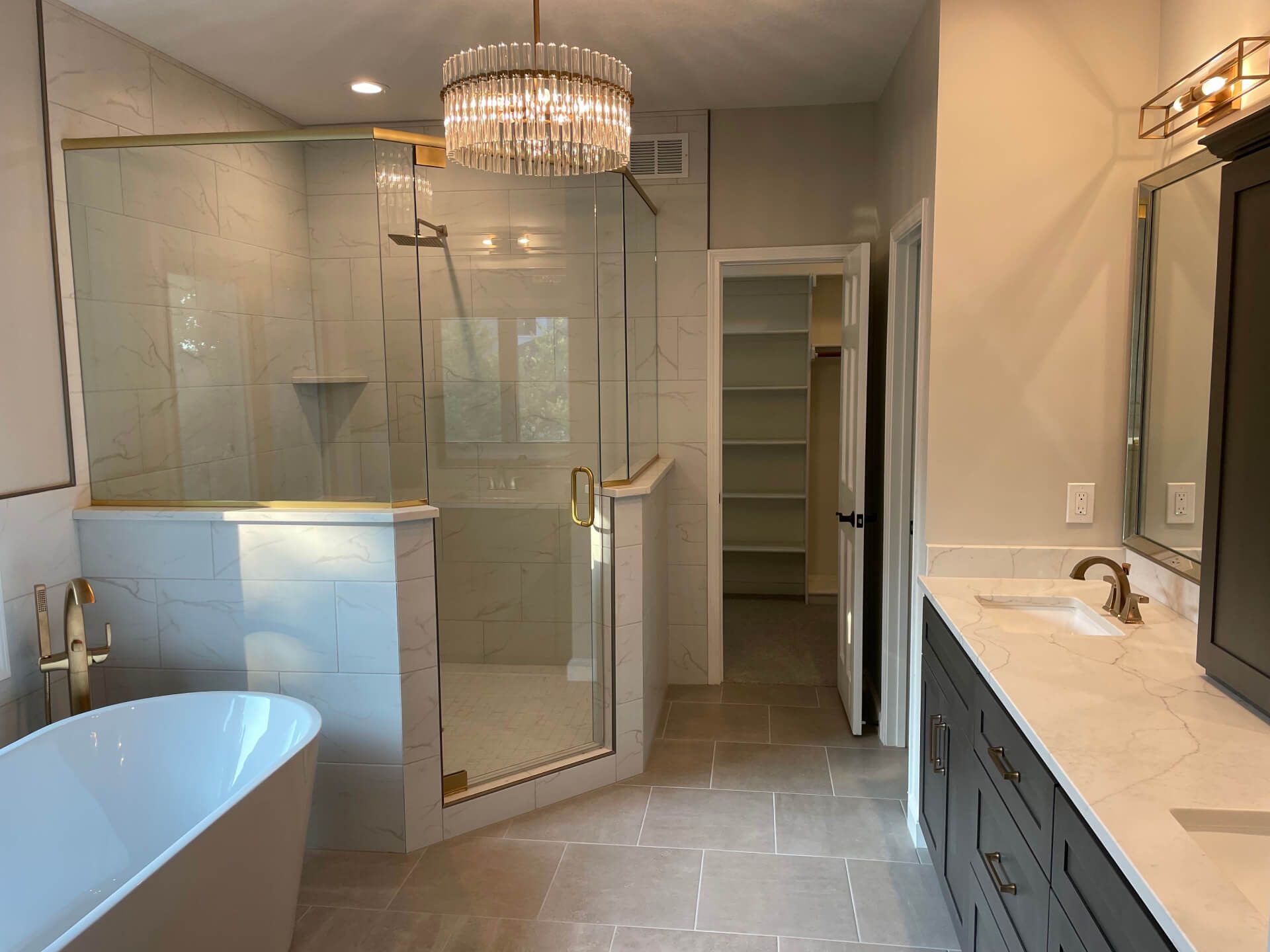 A bathroom with a bathtub , sink , and shower.