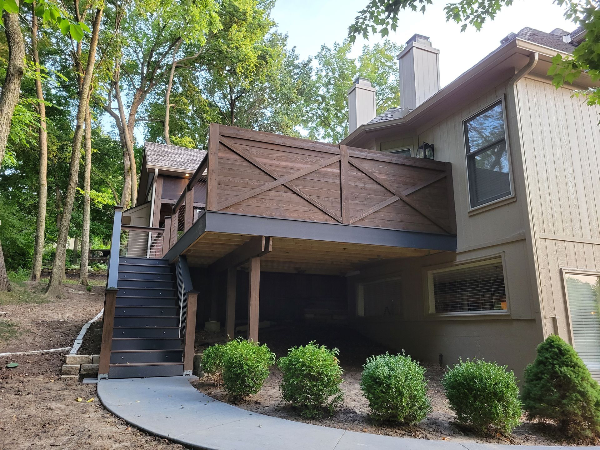 A house with a large deck and stairs leading up to it