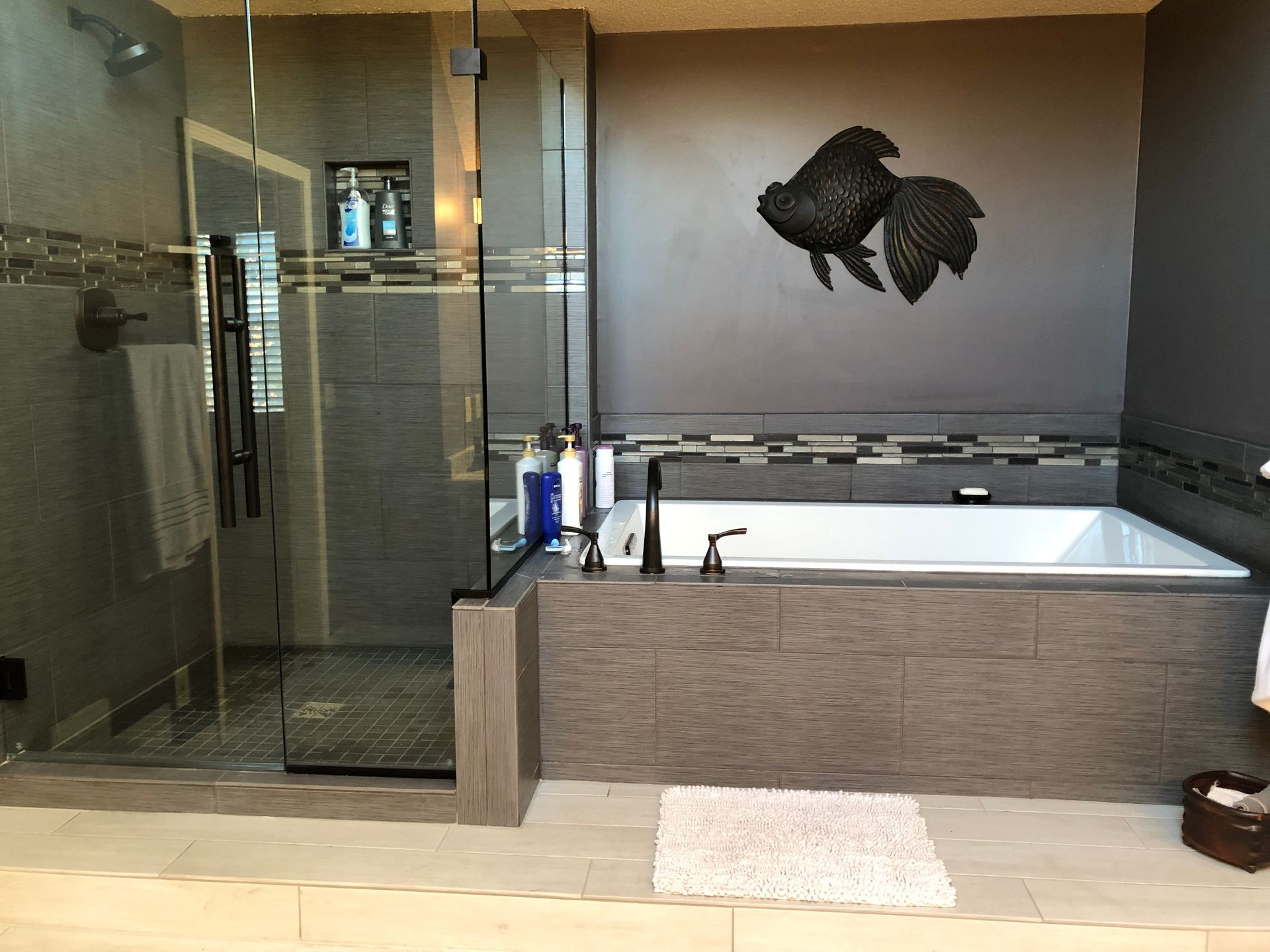 A bathroom with a bathtub and a walk in shower