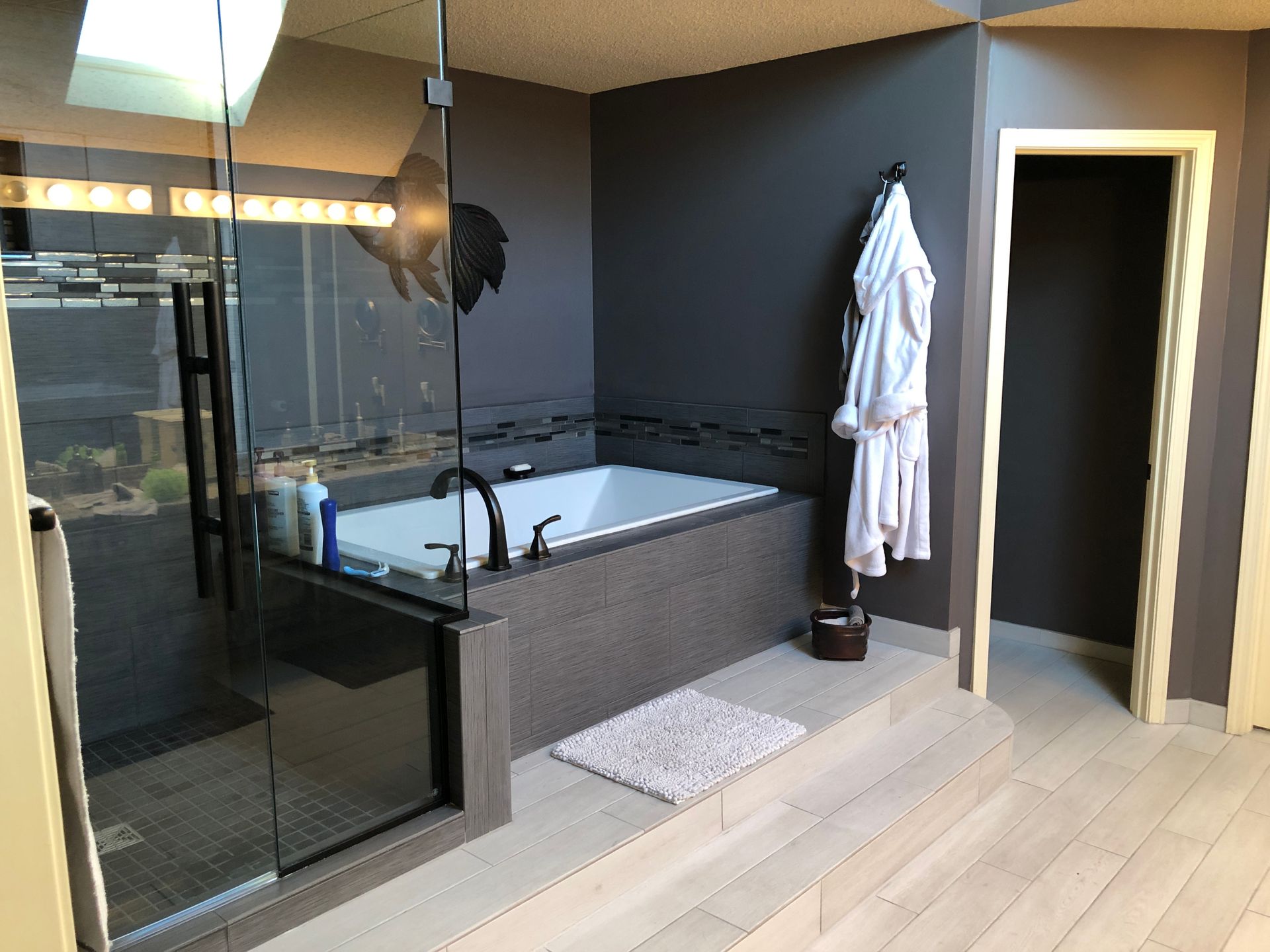 A bathroom with a bathtub and a walk in shower