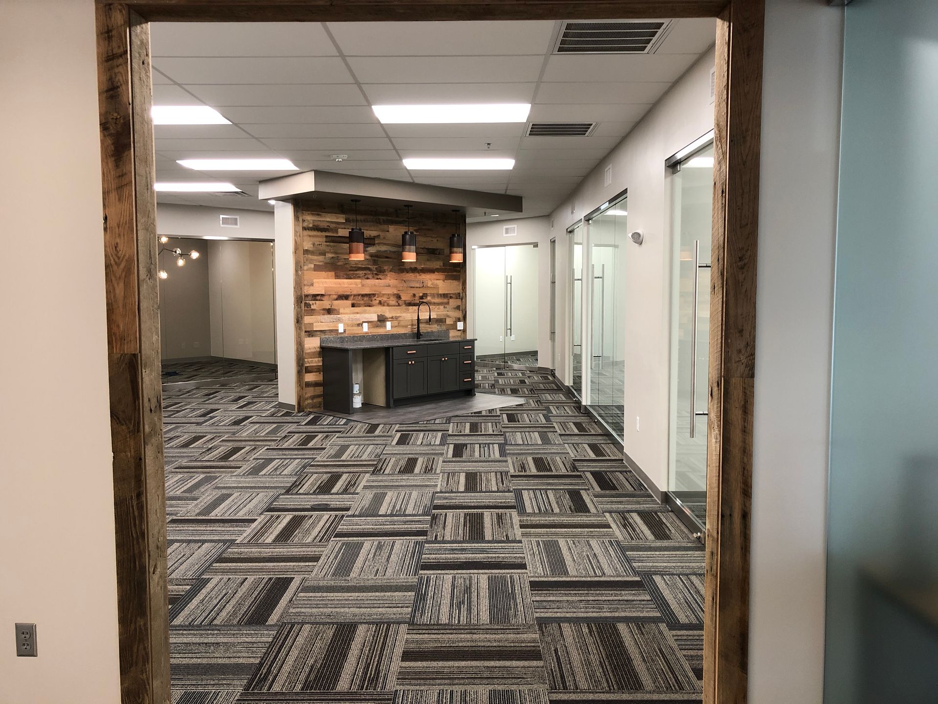 A hallway with a wooden frame and a carpeted floor