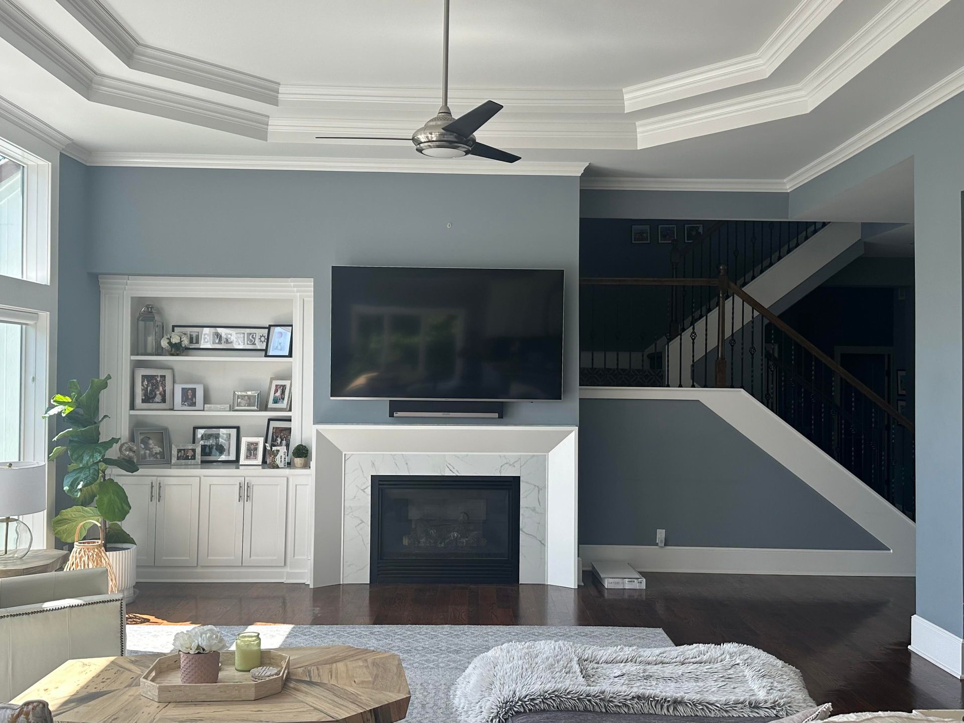 A living room with a fireplace and a flat screen tv.