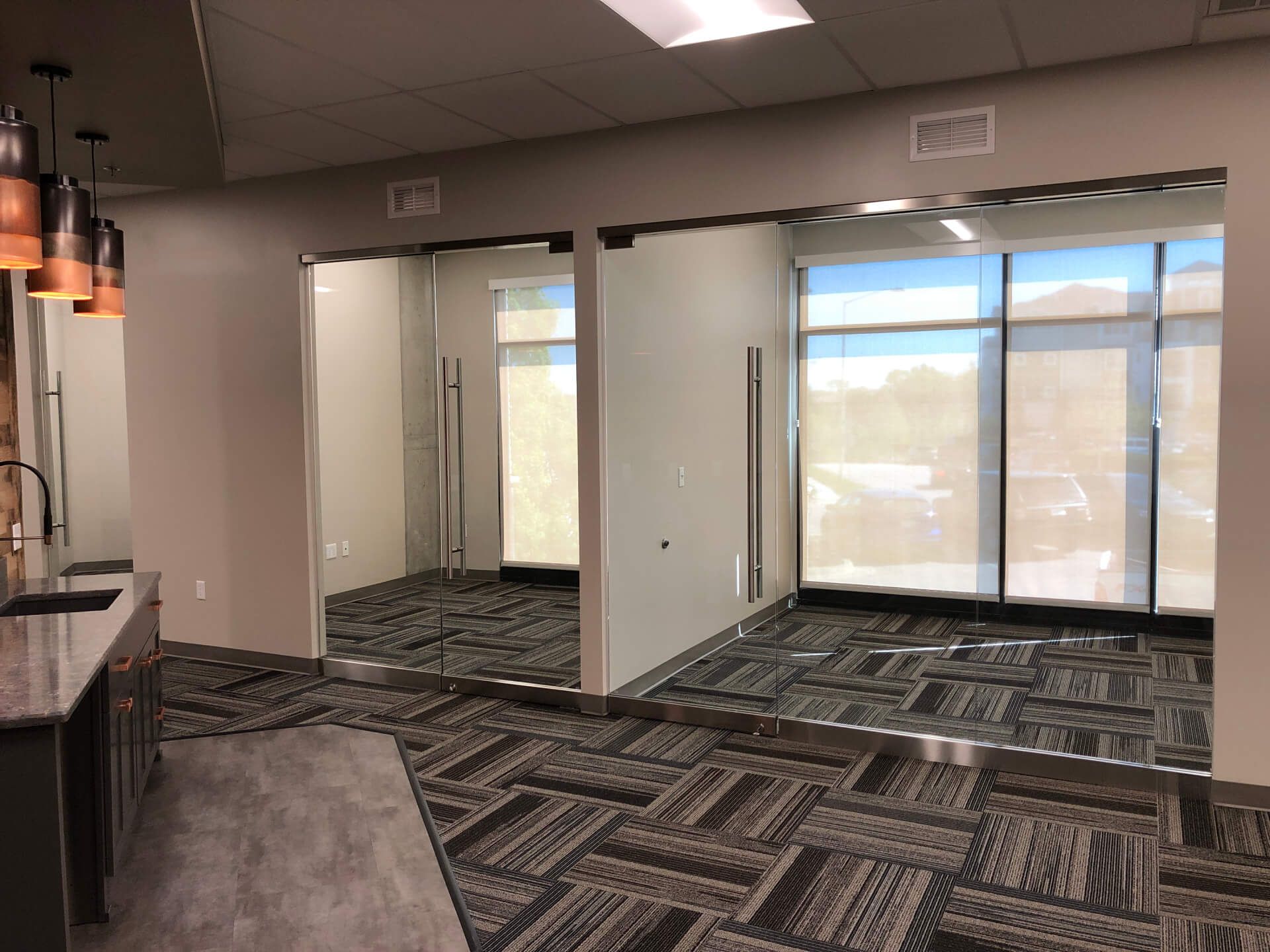 A large room with a lot of windows and a carpeted floor.