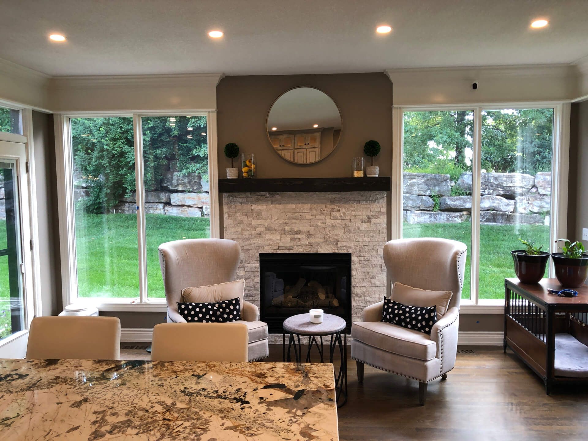 A living room with two chairs and a fireplace.