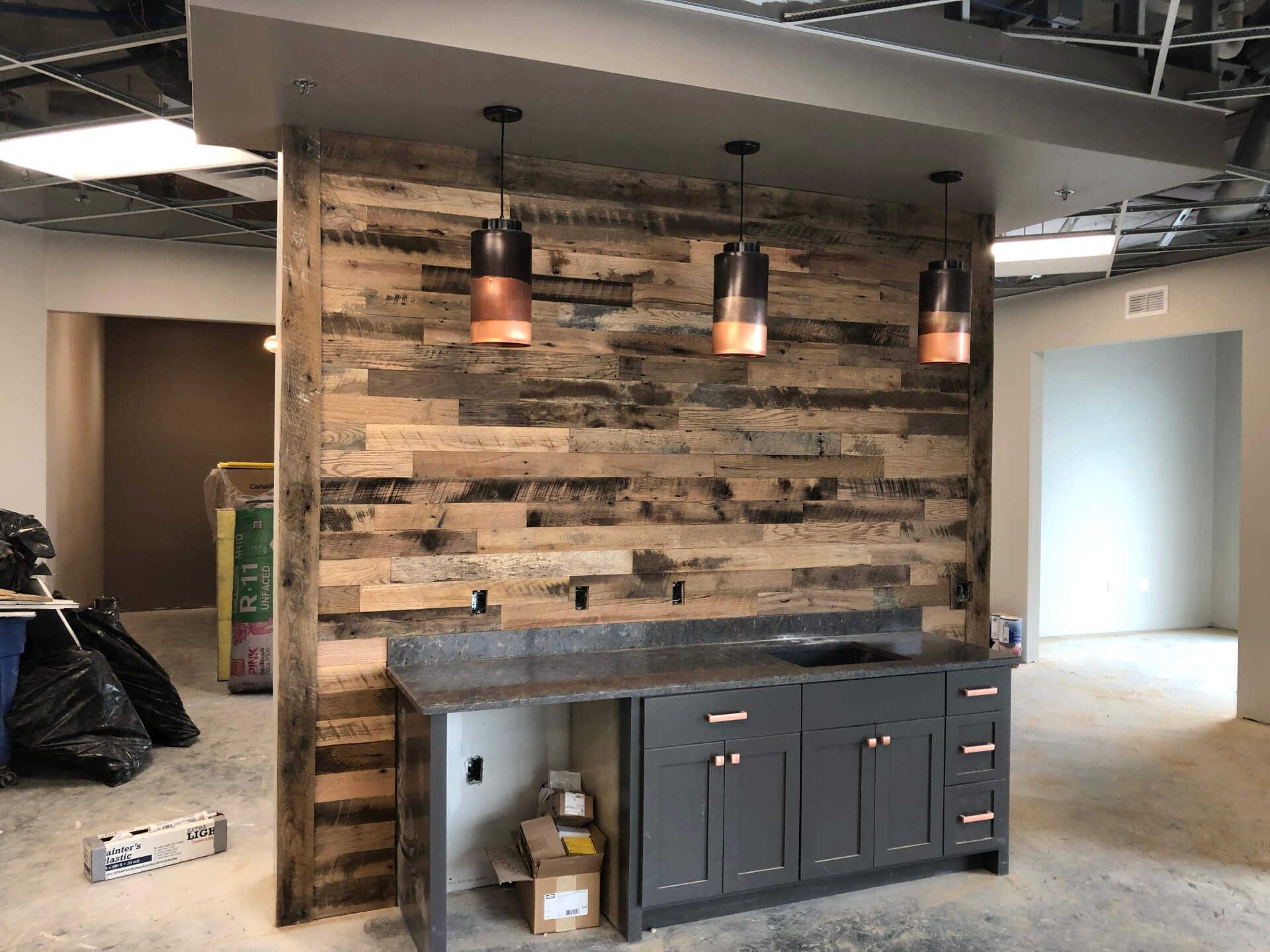 A room with a wooden wall and a counter in it.