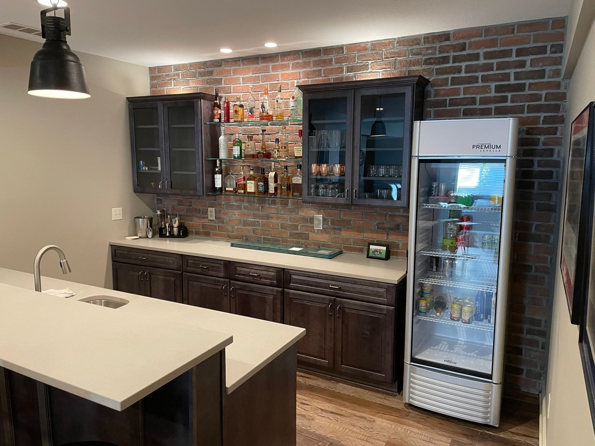 A kitchen with a refrigerator and a bar.