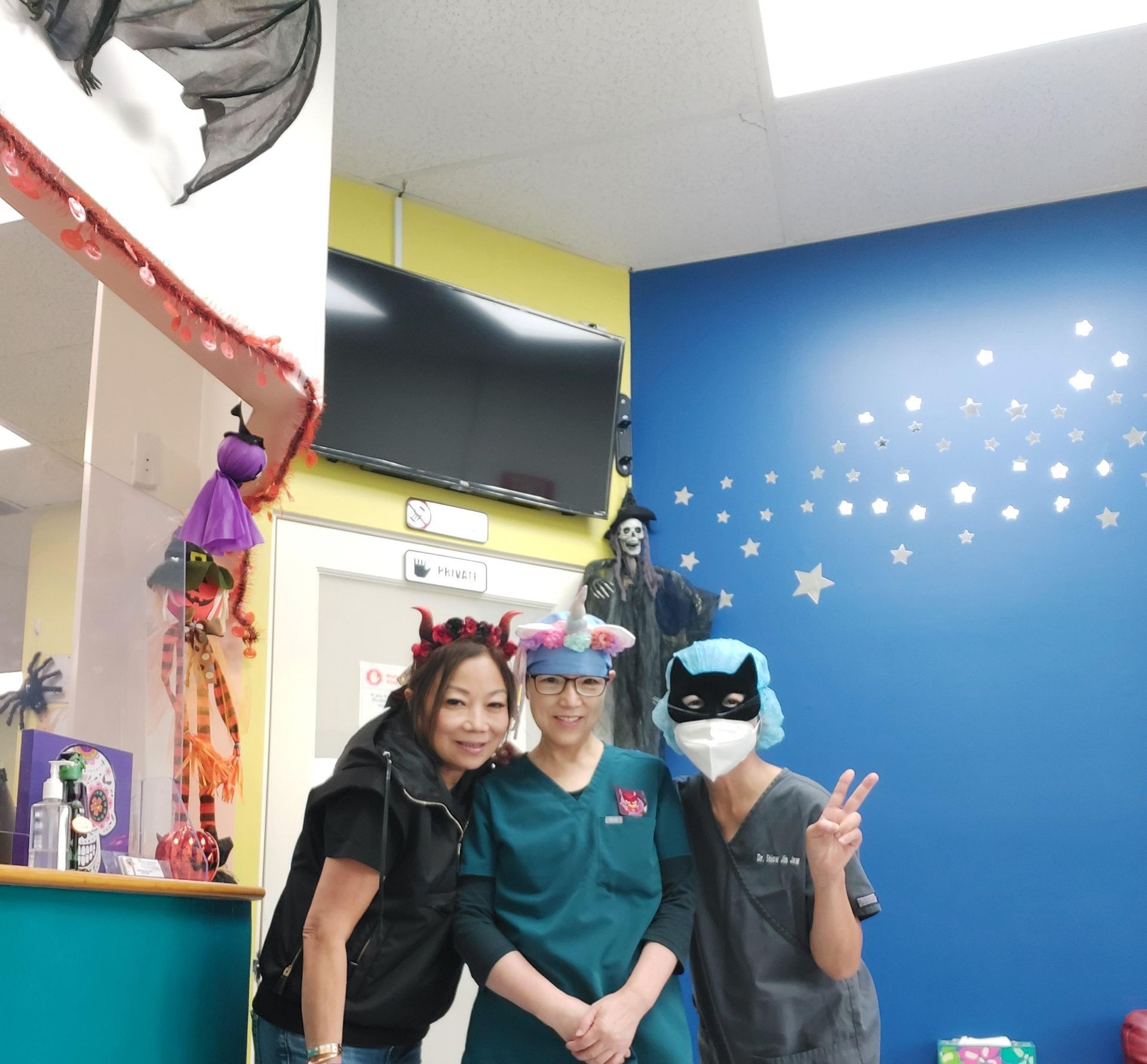 A group of staff for a picture inside a pediatric dental clinic