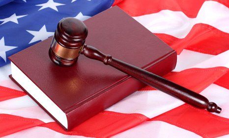 Law gavel and book on American flag
