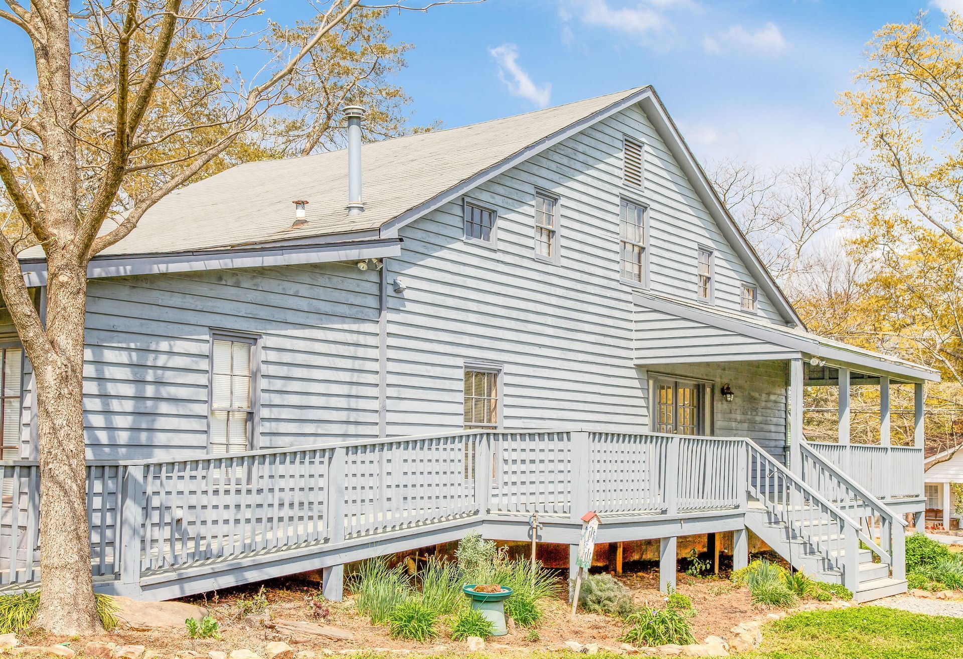 Blue house with porch and ramp.
