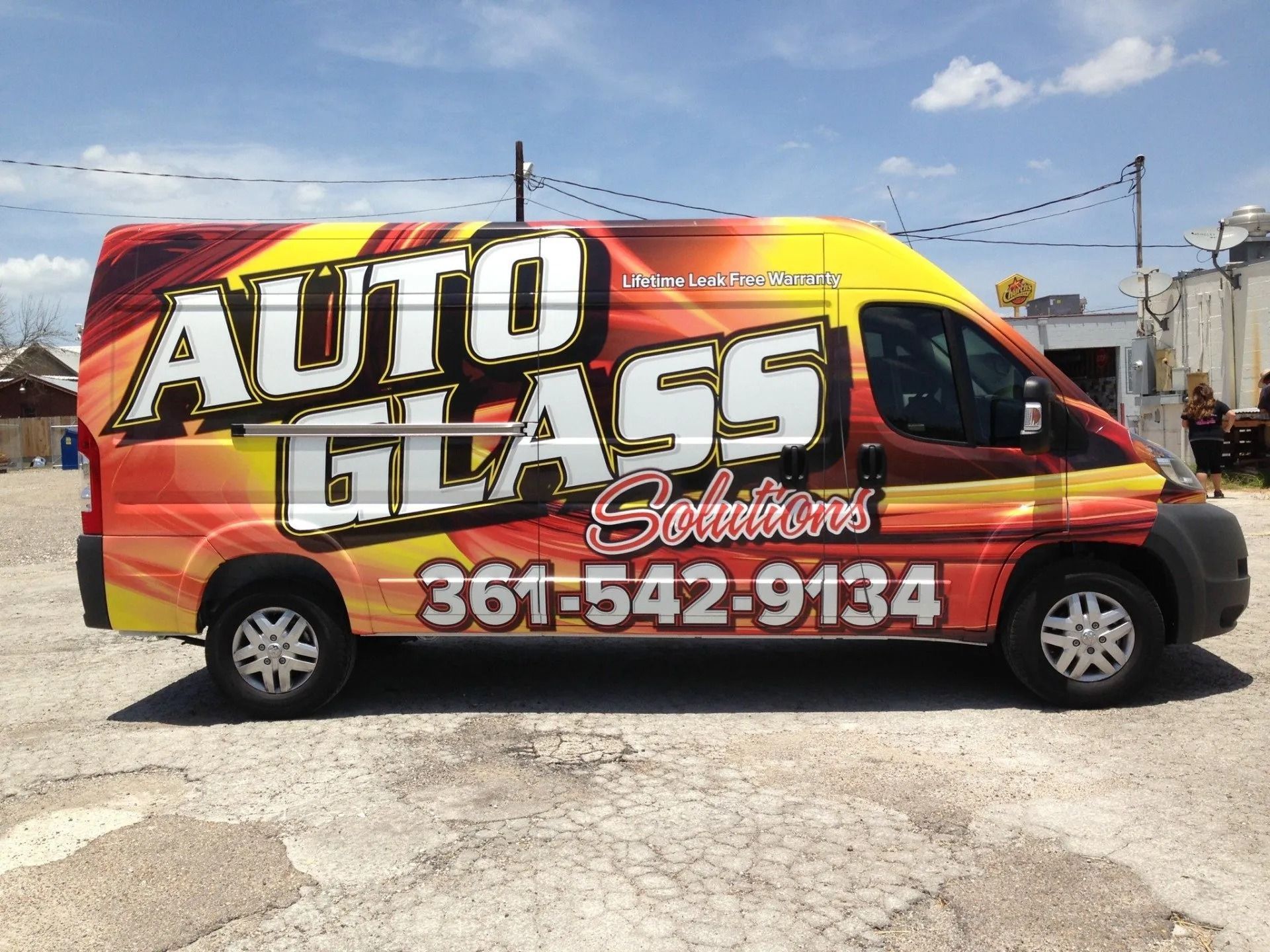 Auto Glass Solutions van with company logo and phone number.