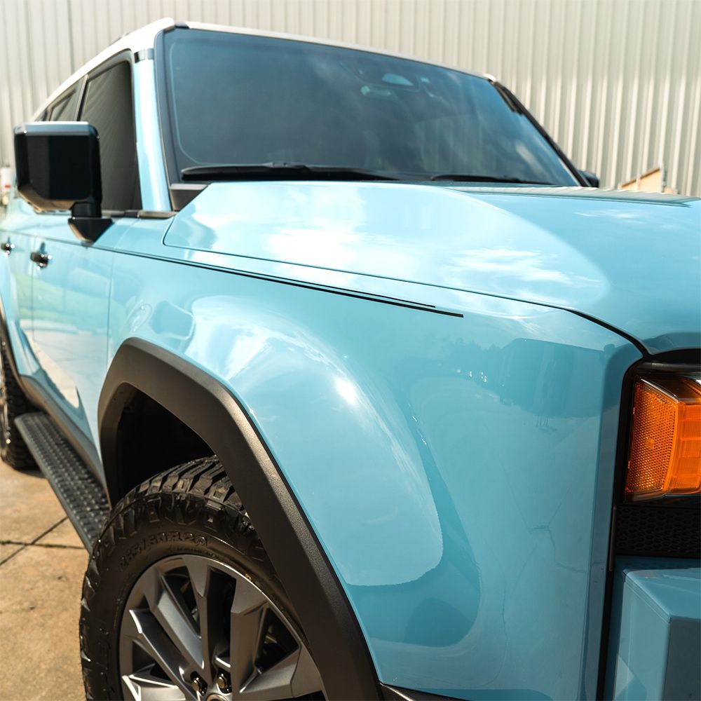 Light blue SUV with black accents and tinted windows.