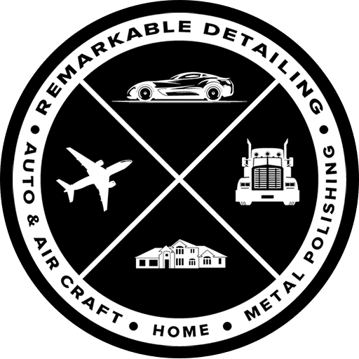 Black and white logo: Car, plane, semi-truck, house, divided by diagonal lines, surrounded by 