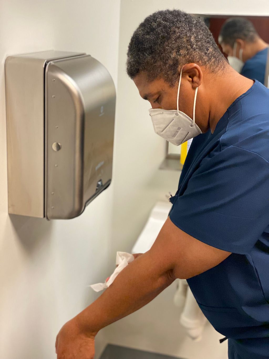 Male Health Professional Trainee drying his hands
