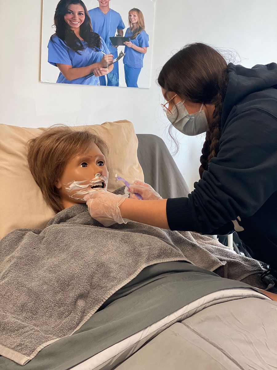 Health Professional Trainee attending to a medical manikin