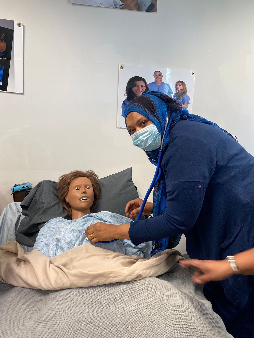 Nursing assistant trainee using a stethoscope