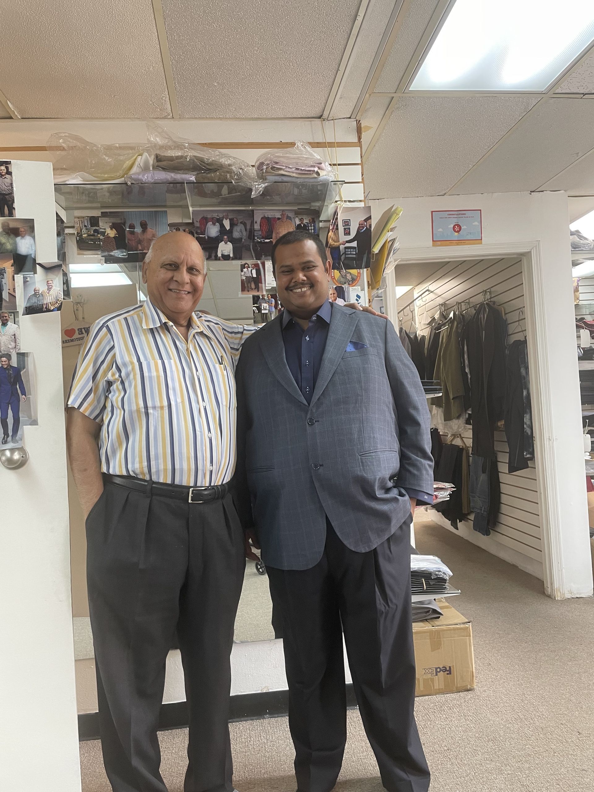 Two men standing next to each other in a clothing store