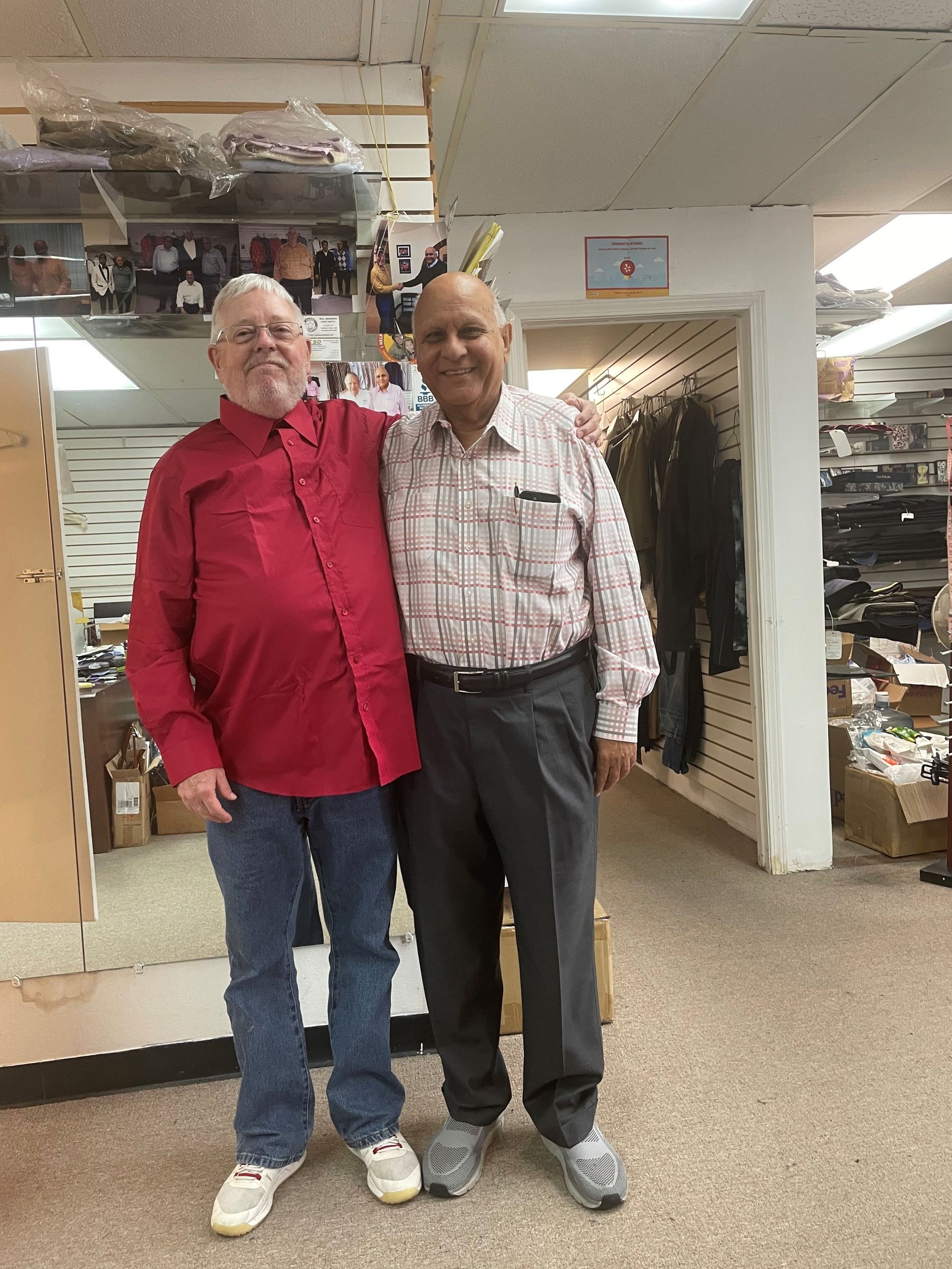 Two men are standing next to each other in a store.