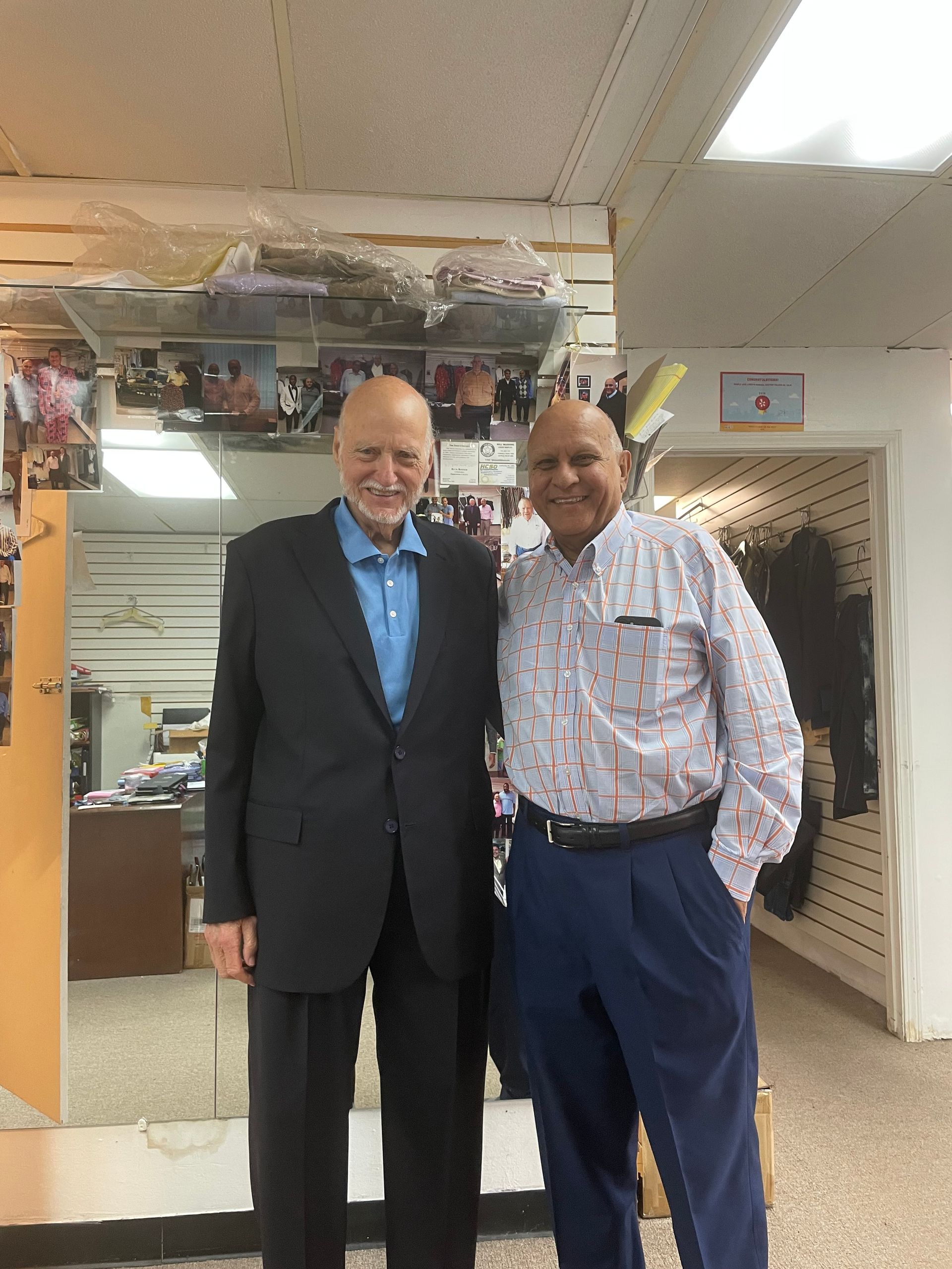 Two men are posing for a picture in a store