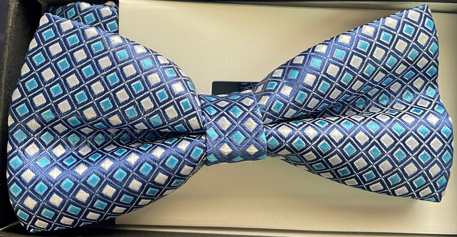 A blue and white bow tie is in a box