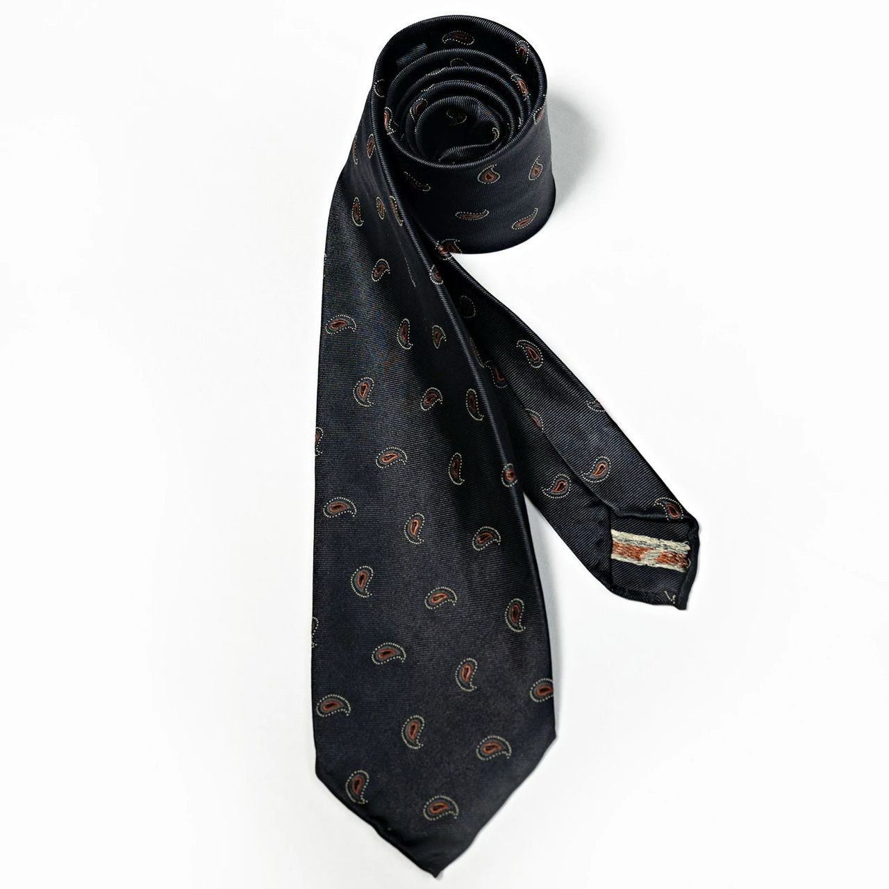 A black tie with gold paisley on it