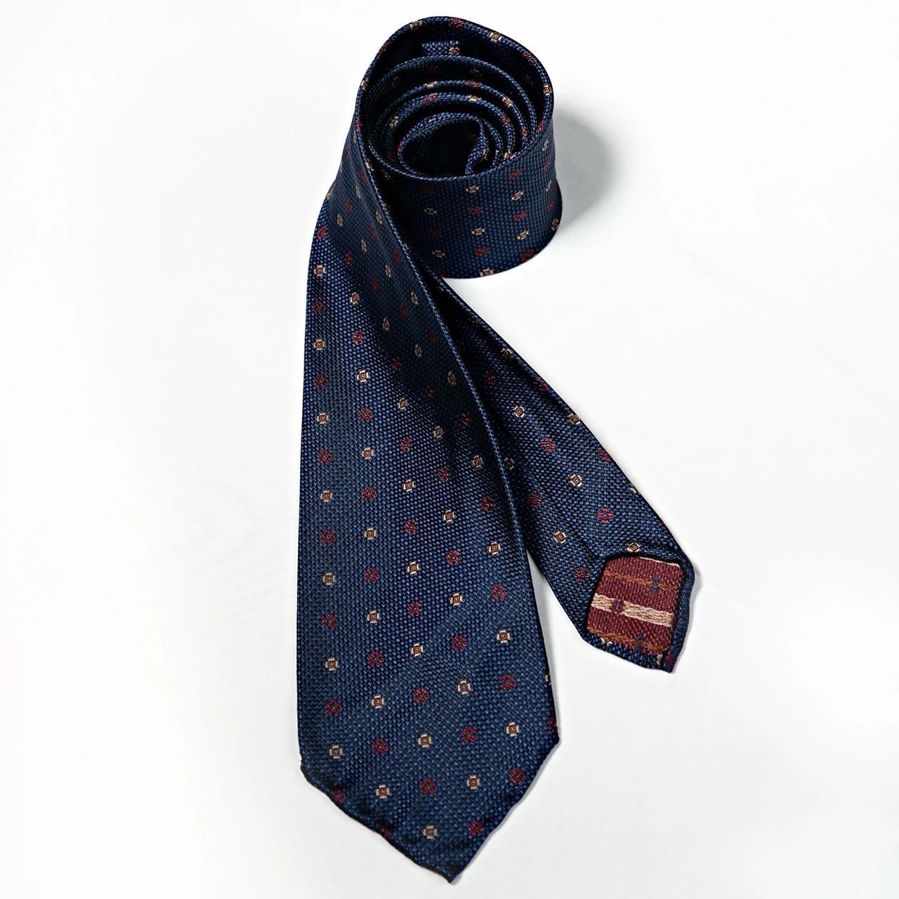 A blue tie with red polka dots on it
