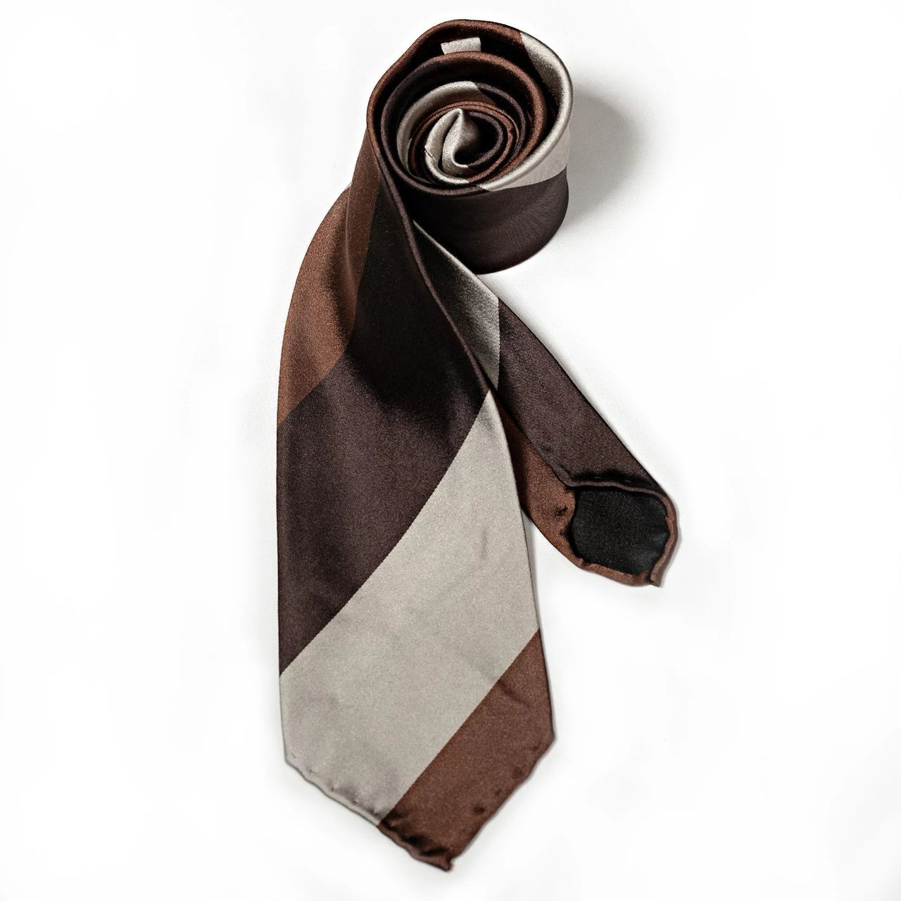 A brown and white striped tie on a white background