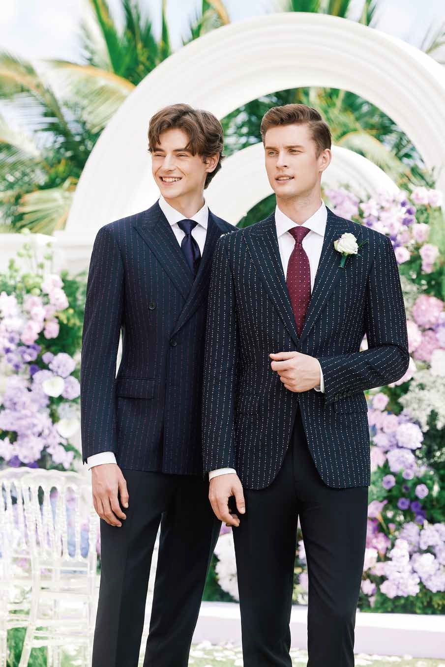 Two men in suits and ties are standing next to each other.