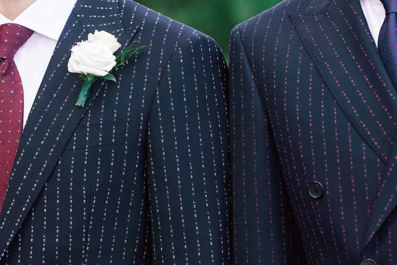 Two men in suits and ties are standing next to each other