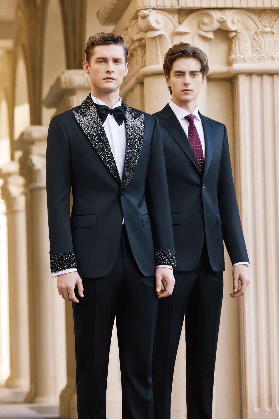 Two men in suits and ties are standing next to each other.