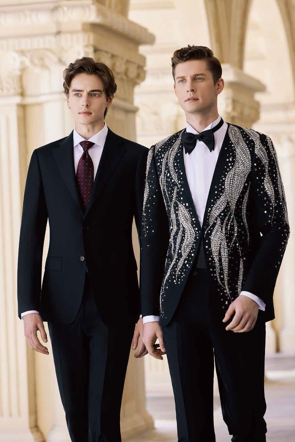 Two men in suits and ties are standing next to each other.