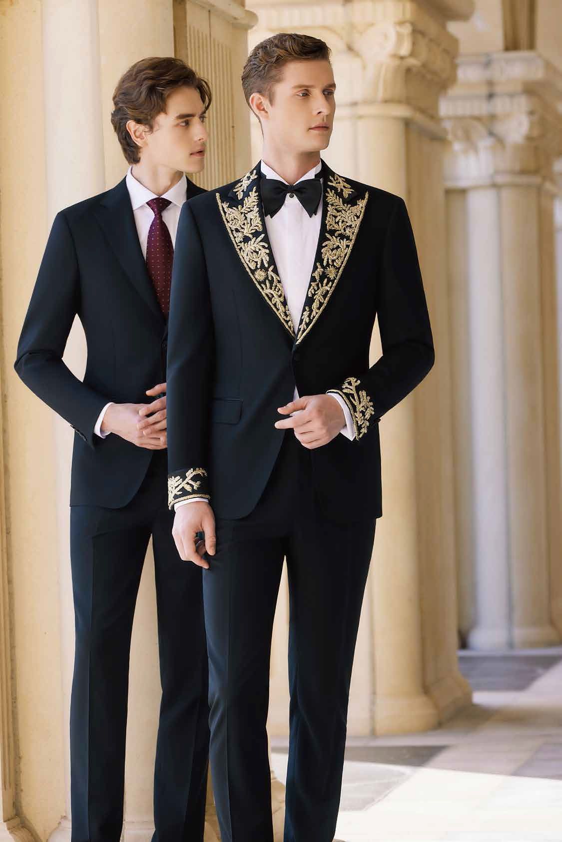 Two men in tuxedos and ties are standing next to each other.