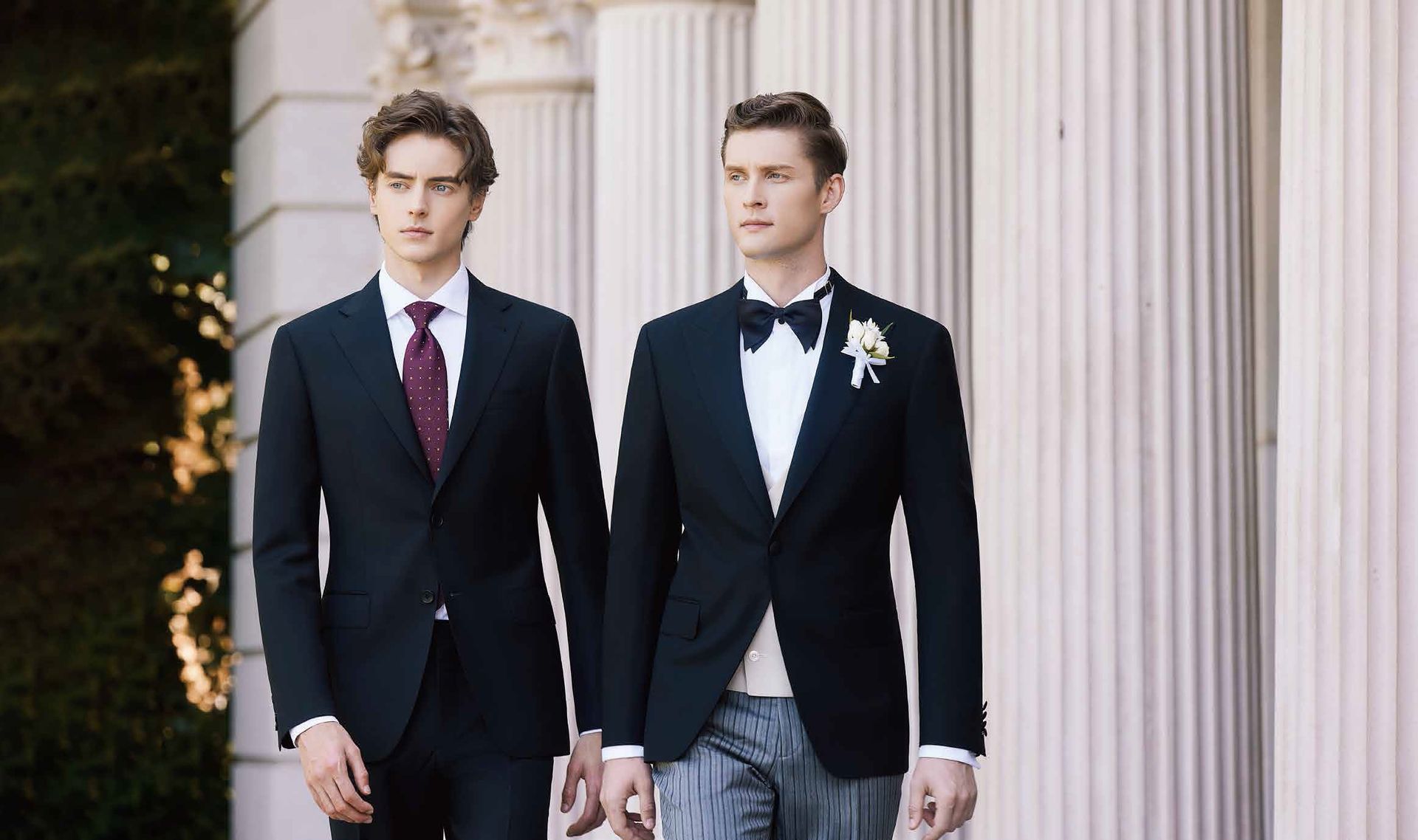 Two men in suits and ties are walking next to each other.