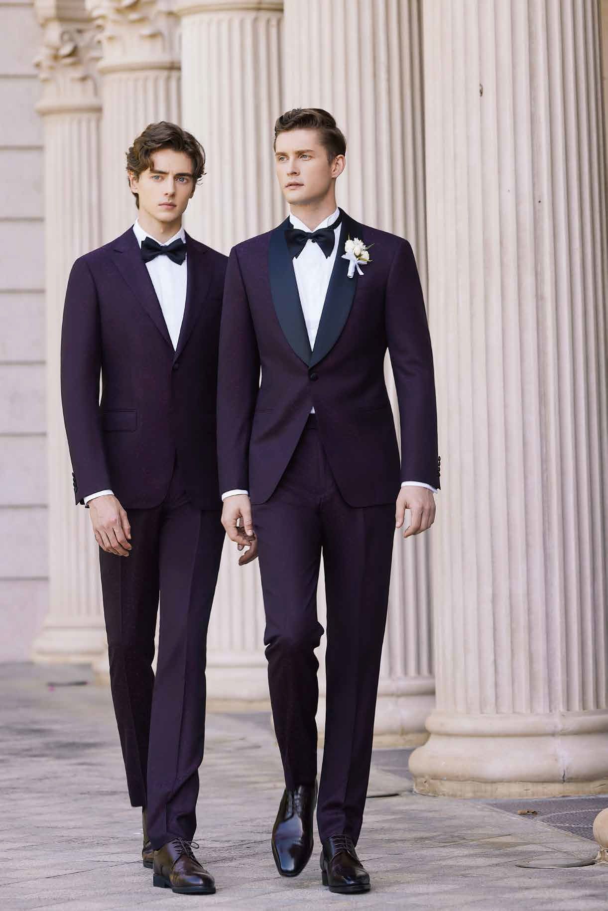 Two men in suits and bow ties are walking next to each other.